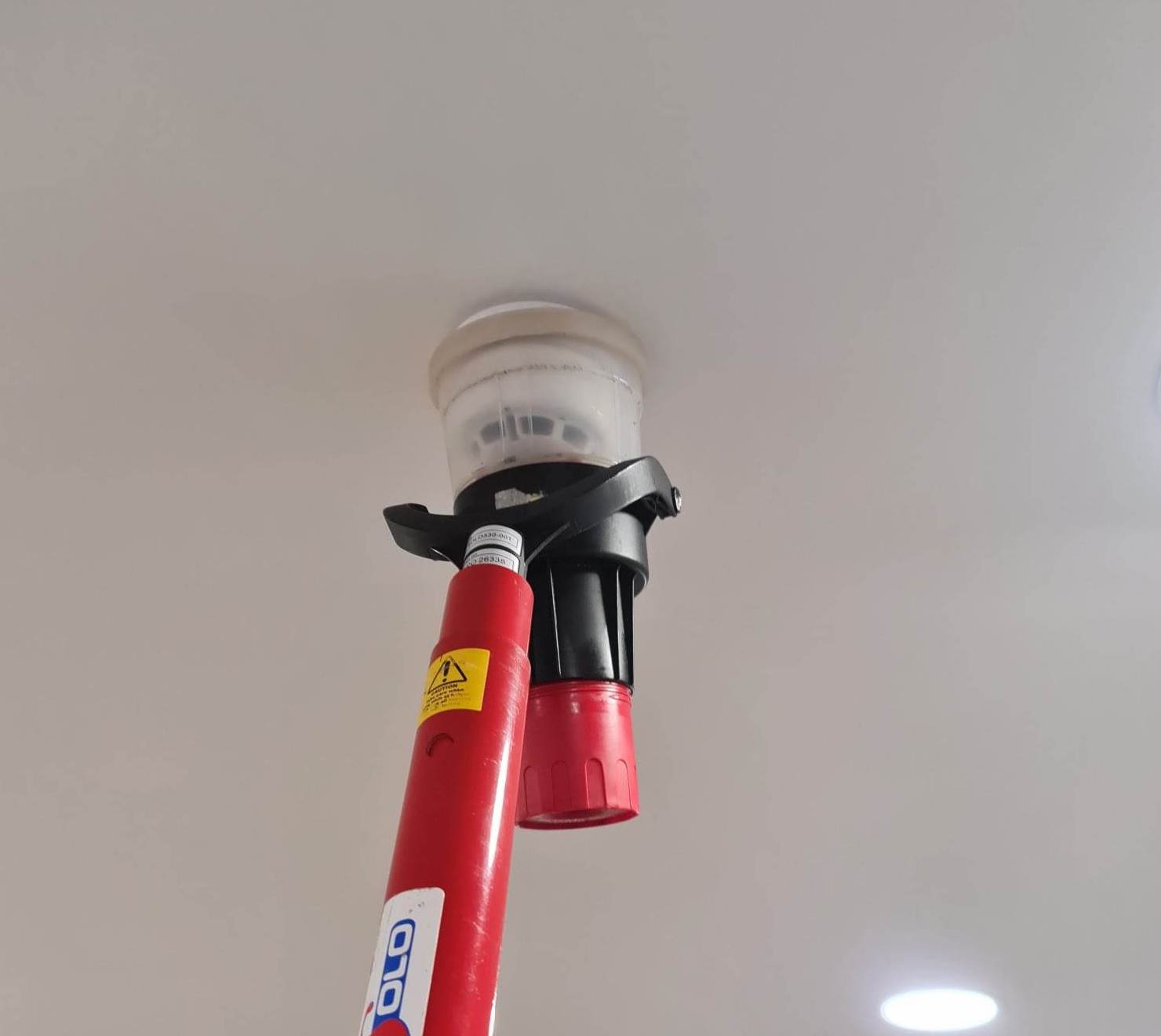 Fire alarm being maintained by a technician